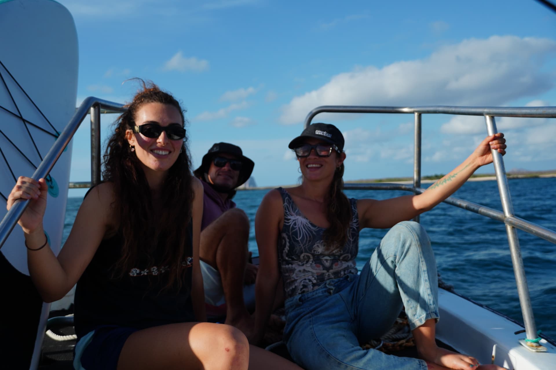 Guests smiling on the boat after a paddle session