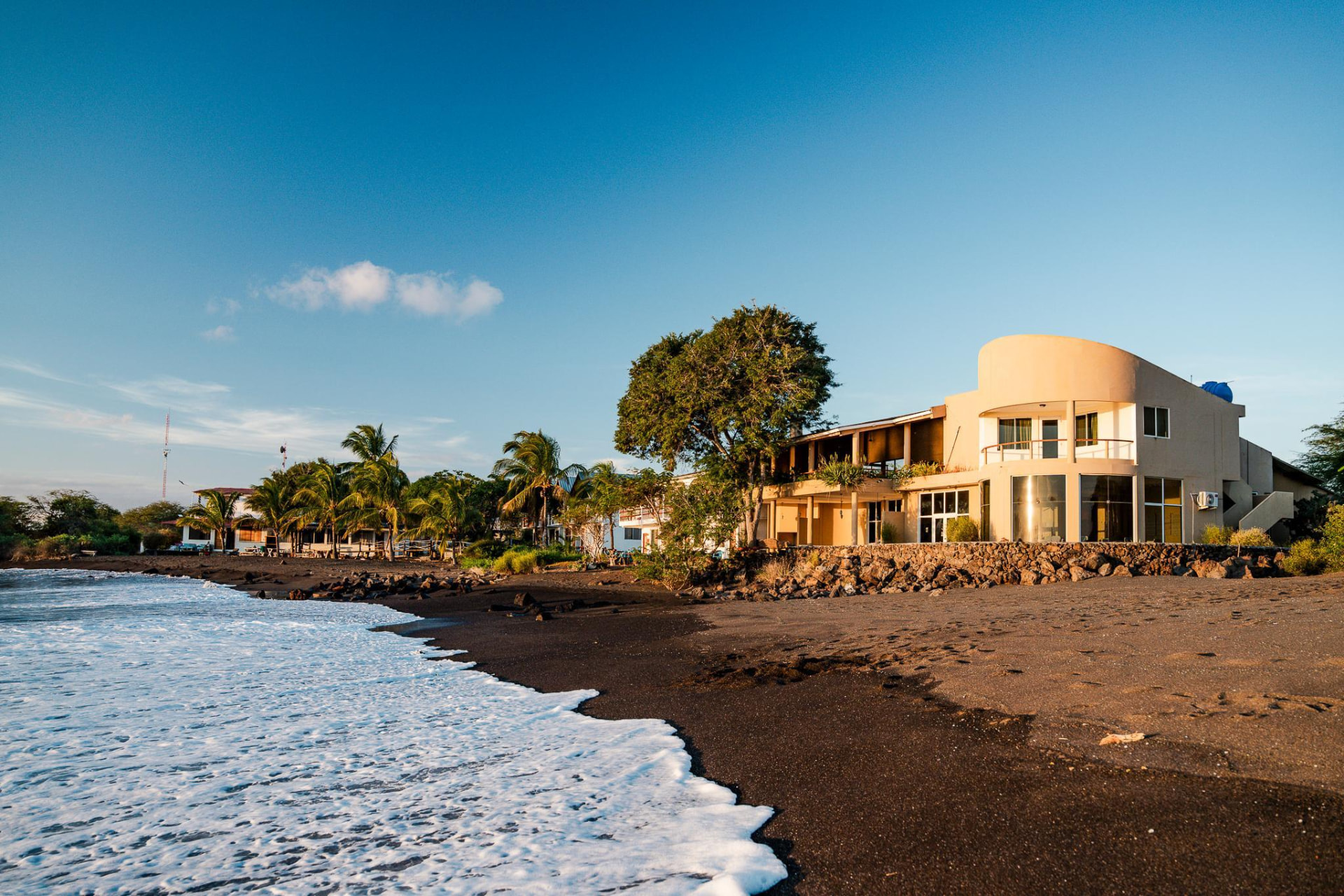 Black sand beach and beachfront lodging on Floreana Island