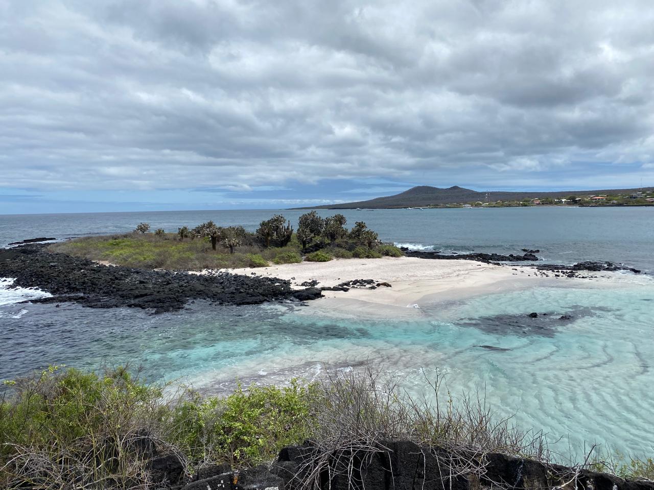 Turquoise bay and cactus islet on Floreana Island