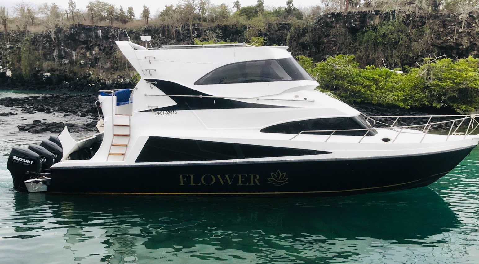 The Flower ferry cruising turquoise Galápagos water