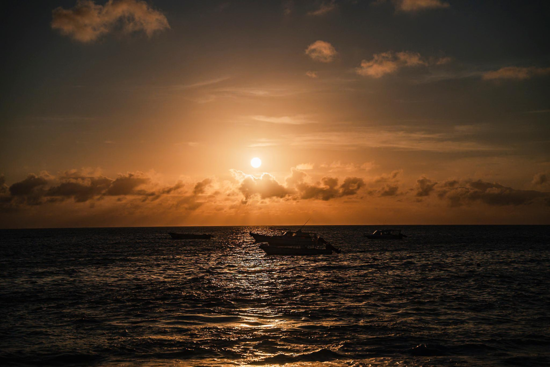 Sunset over fishing boats off Floreana Island